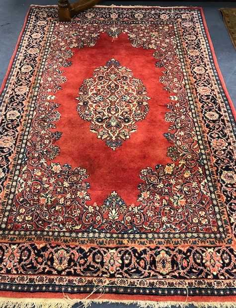 A red ground rug 245 x 165cm
